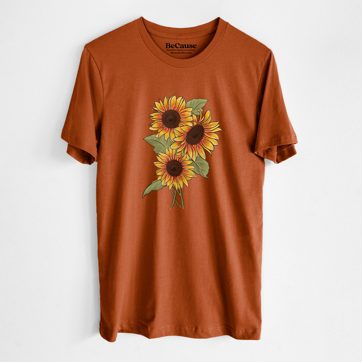 Autumn lightweight cotton t-shirt laid flat, printed with a full-color illustration of a bunch of yellow and orange sunflowers.