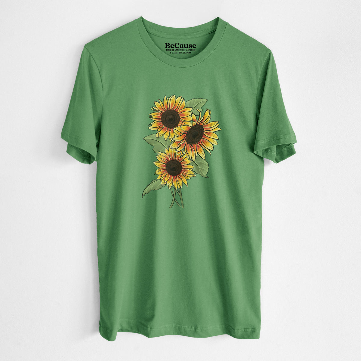 Leaf green lightweight cotton t-shirt laid flat, printed with a full-color illustration of a bunch of yellow and orange sunflowers.
