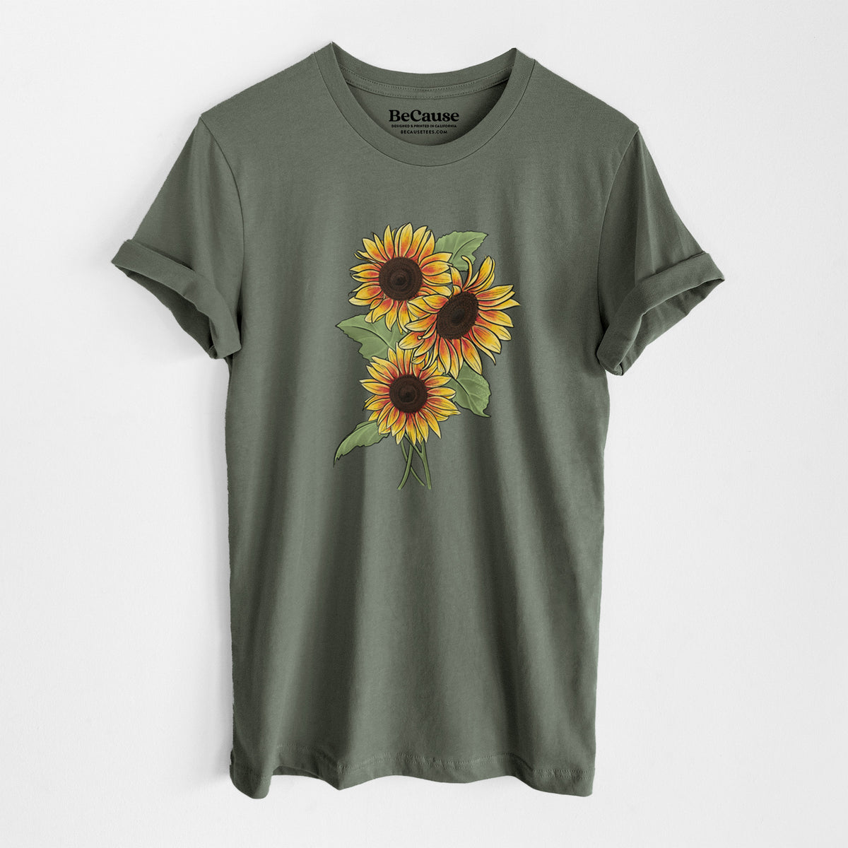 Military green lightweight cotton t-shirt laid flat, printed with a full-color illustration of a bunch of yellow and orange sunflowers.