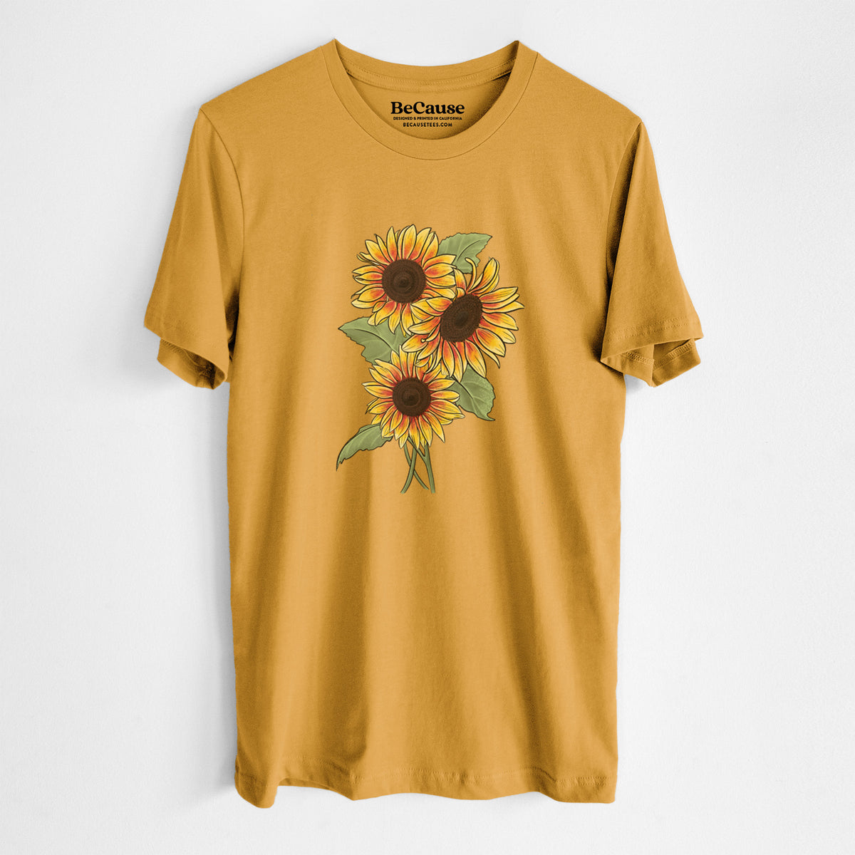 Mustard yellow lightweight cotton t-shirt laid flat, printed with a full-color illustration of a bunch of yellow and orange sunflowers.