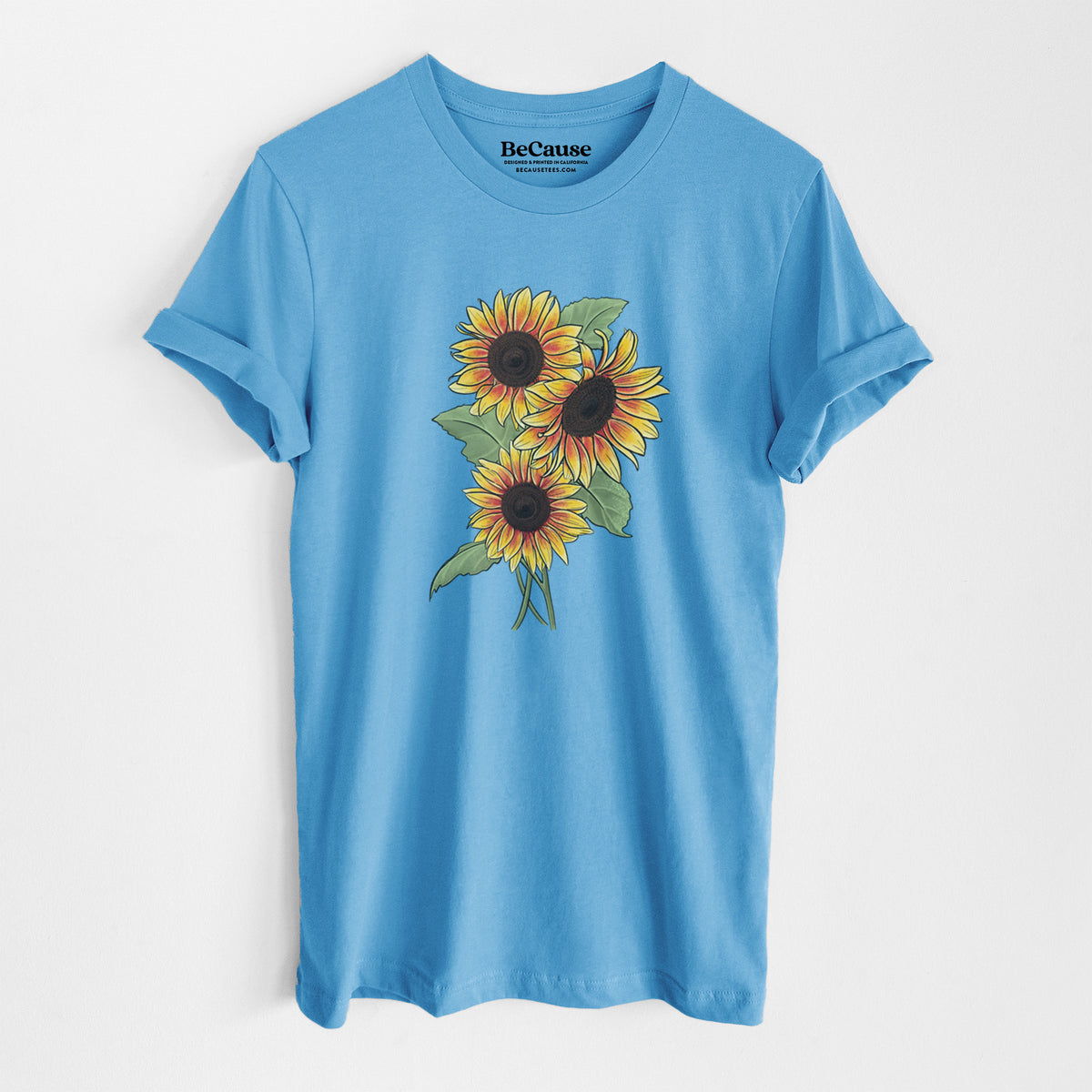 Ocean blue lightweight cotton t-shirt laid flat, printed with a full-color illustration of a bunch of yellow and orange sunflowers.