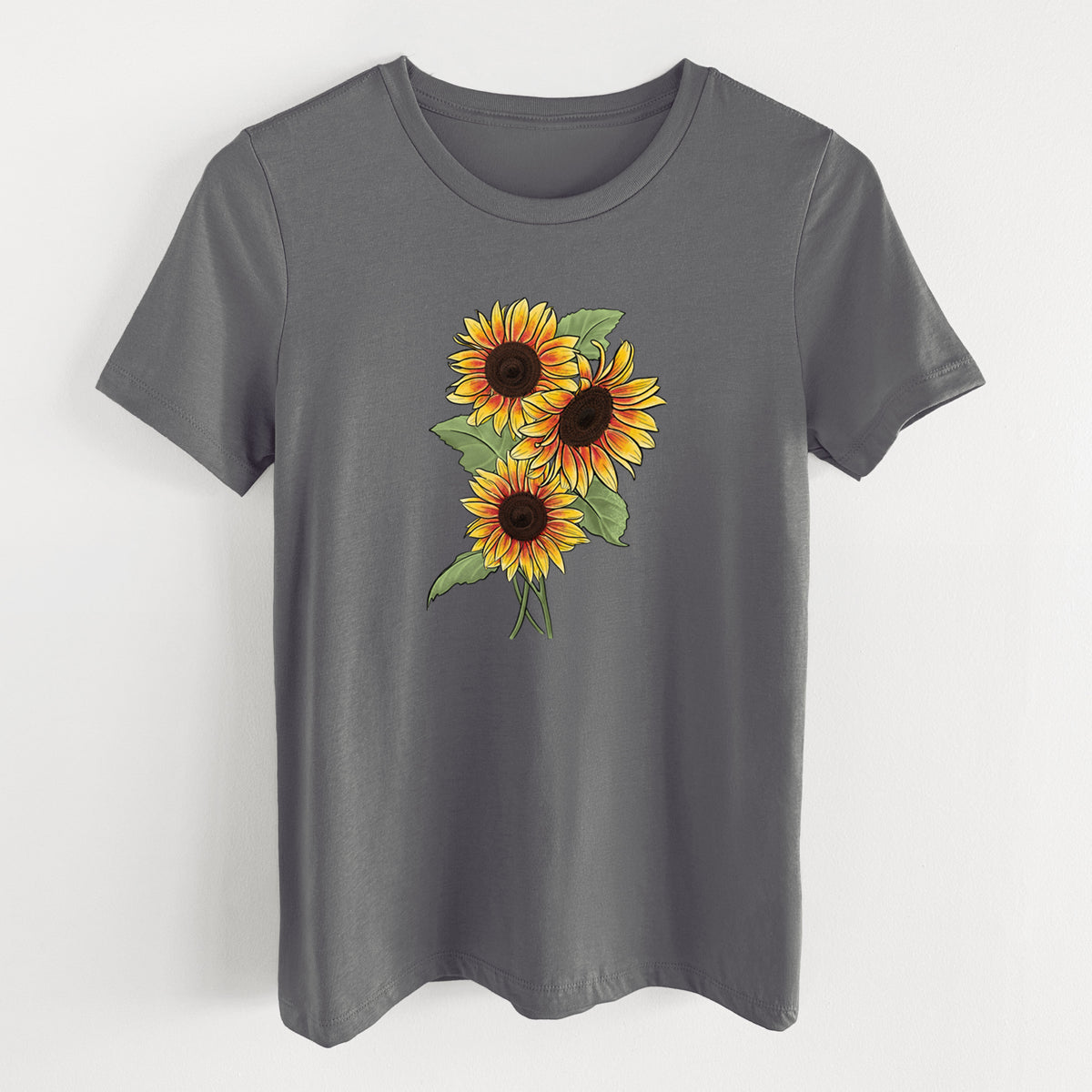 Asphalt women's relaxed fit cotton t-shirt laid flat, printed with a full-color illustration of a bunch of yellow and orange sunflowers.