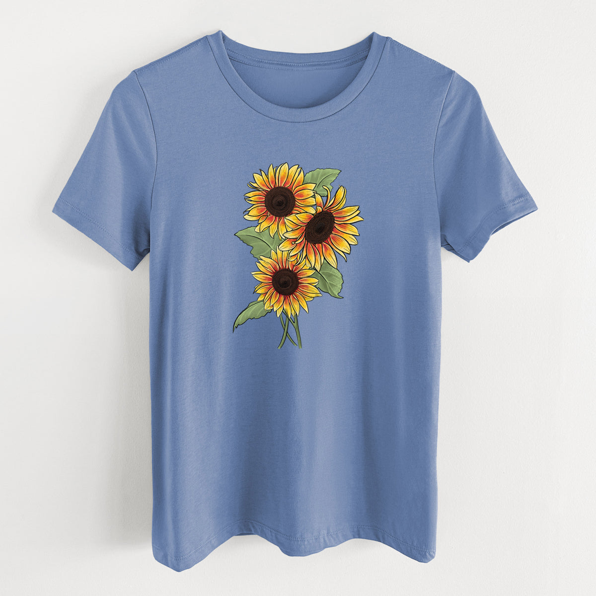 Blue bell women's relaxed fit cotton t-shirt laid flat, printed with a full-color illustration of a bunch of yellow and orange sunflowers.