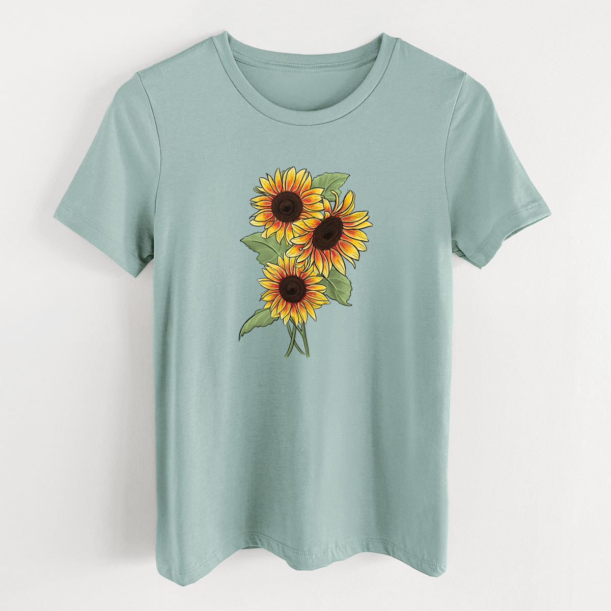 Dusty blue women's relaxed fit cotton t-shirt laid flat, printed with a full-color illustration of a bunch of yellow and orange sunflowers.