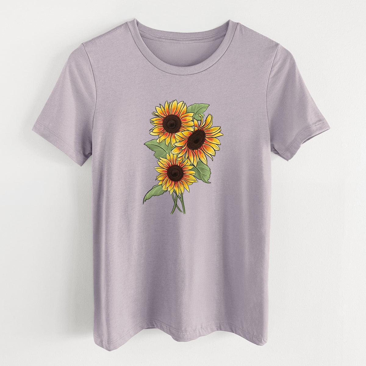 Light violet women's relaxed fit cotton t-shirt laid flat, printed with a full-color illustration of a bunch of yellow and orange sunflowers.