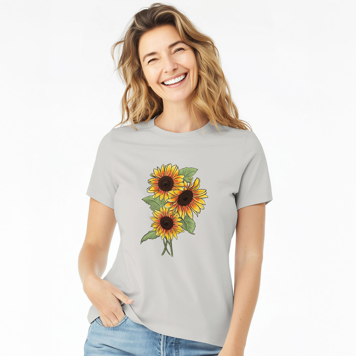 Woman wearing a lunar grey women's relaxed fit cotton t-shirt printed with a full-color illustration of a bunch of yellow and orange sunflowers.