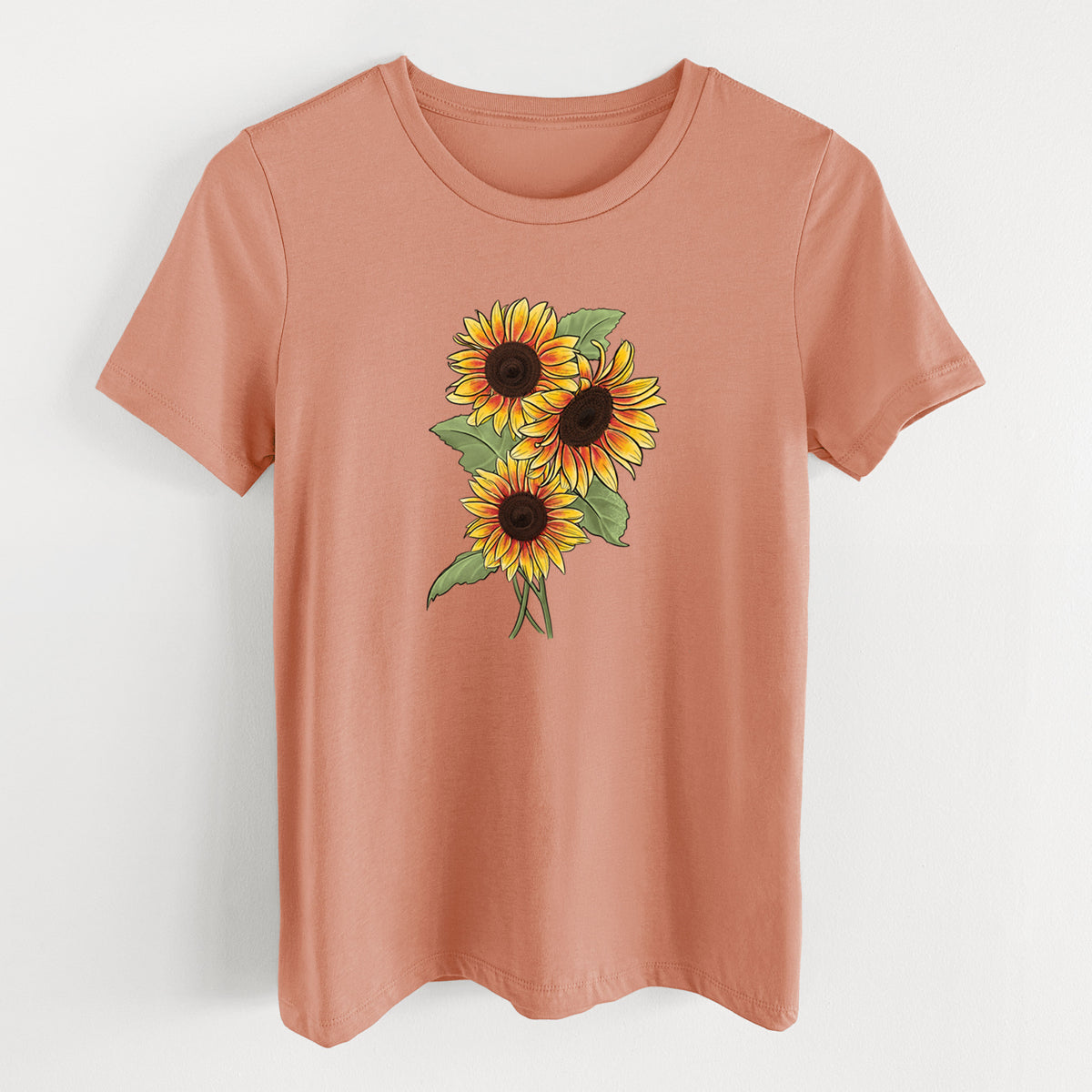 Terracotta orange women's relaxed fit cotton t-shirt laid flat, printed with a full-color illustration of a bunch of yellow and orange sunflowers.