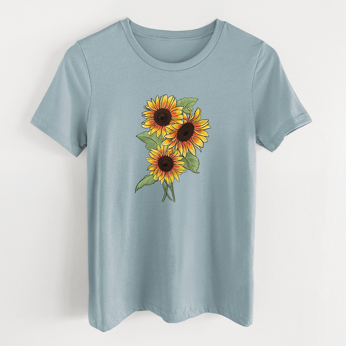 Vintage denim women's relaxed fit cotton t-shirt laid flat, printed with a full-color illustration of a bunch of yellow and orange sunflowers.