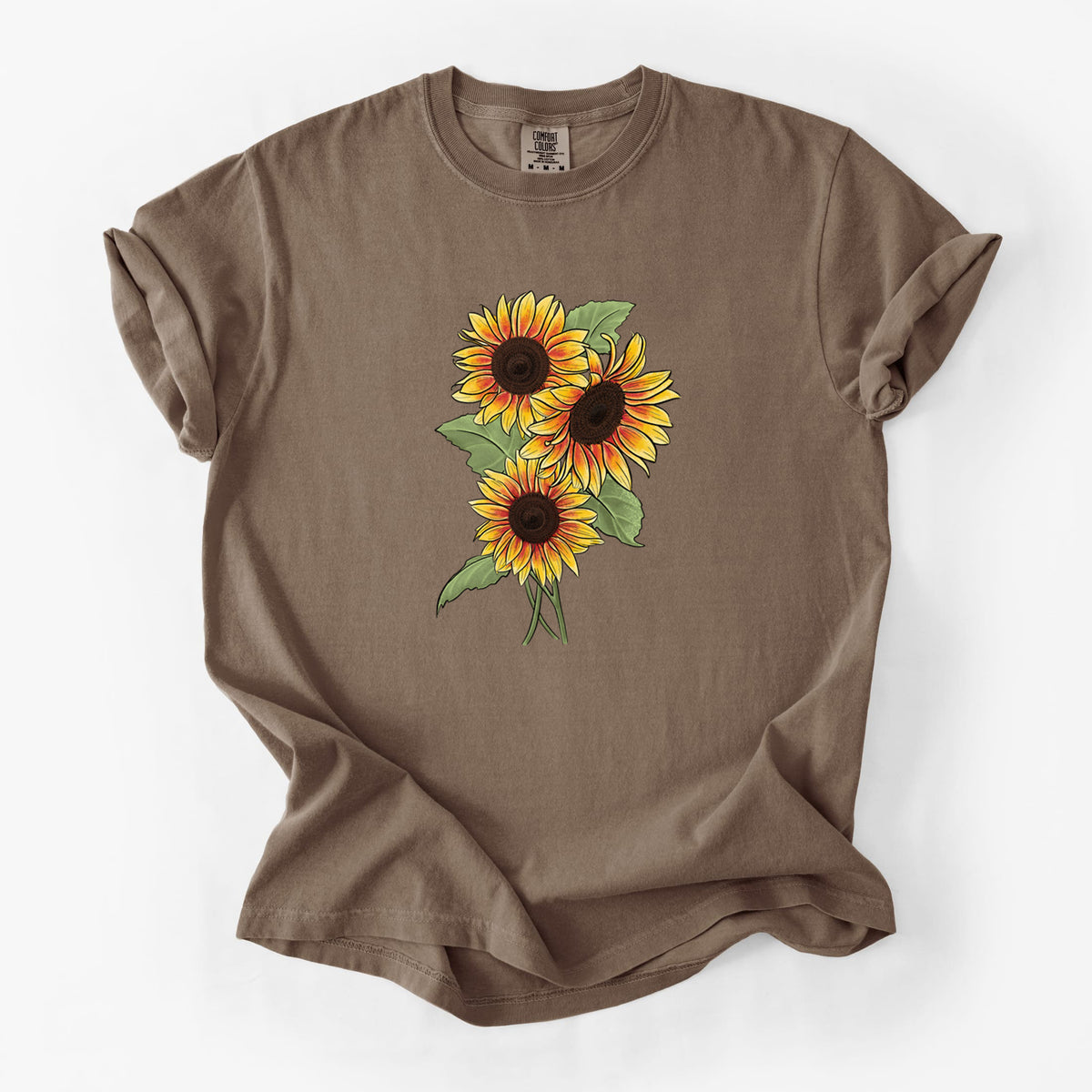 Espresso brown Comfort Colors t-shirt laid flat, printed with a full-color illustration of a bunch of yellow and orange sunflowers.