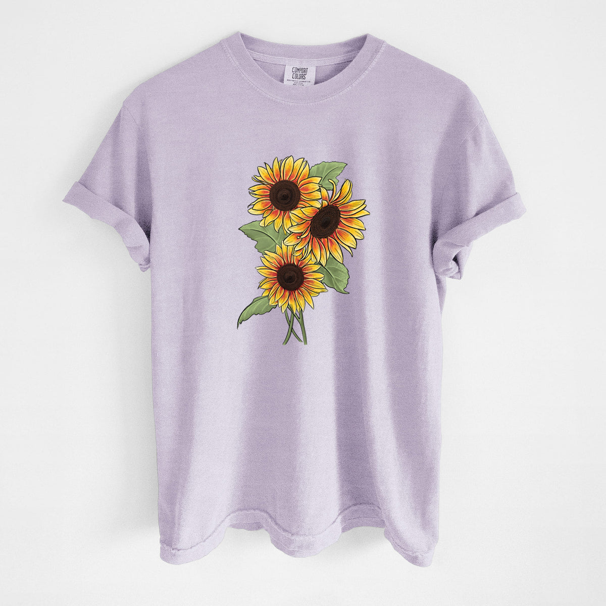 Orchid purple Comfort Colors t-shirt laid flat, printed with a full-color illustration of a bunch of yellow and orange sunflowers.