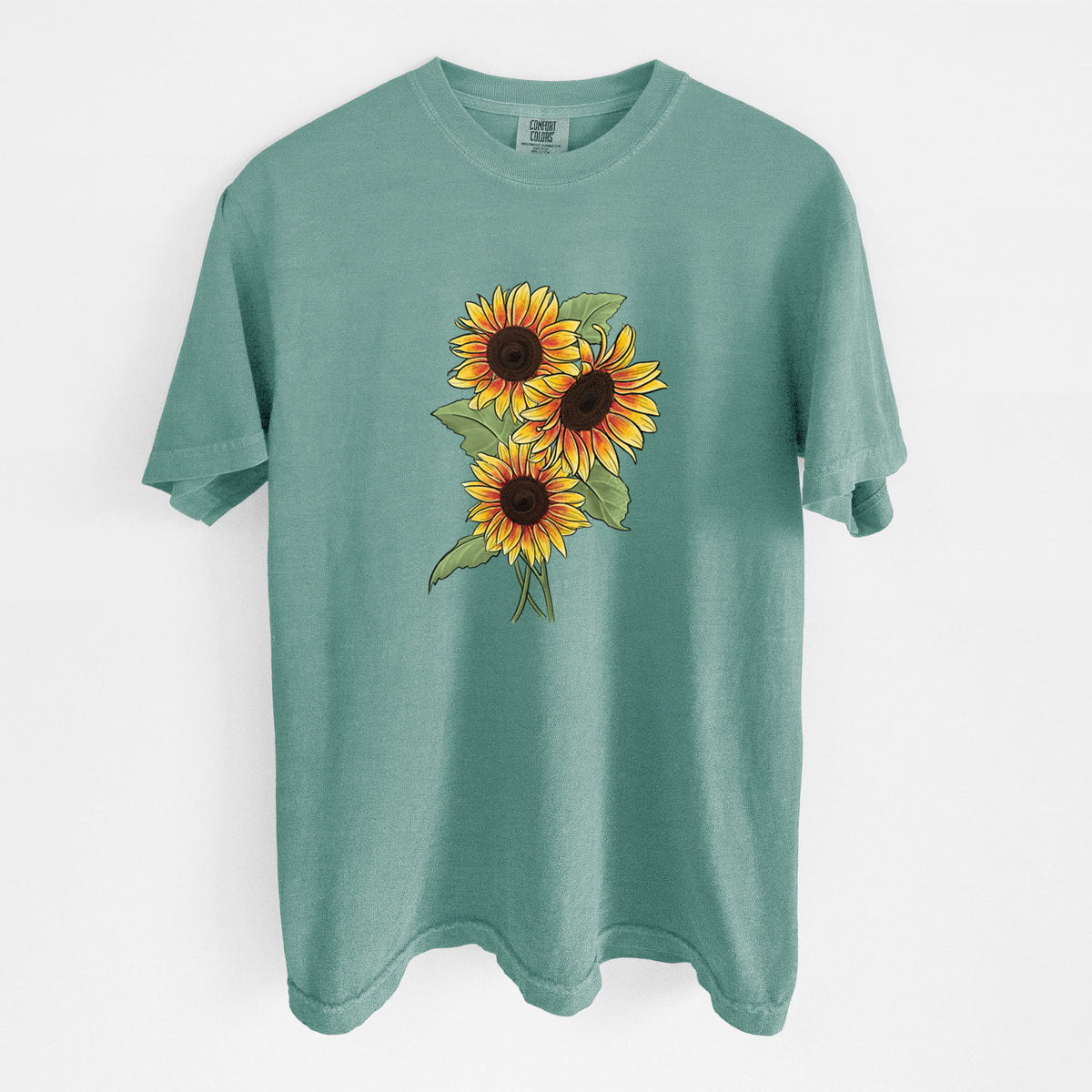 Reef green Comfort Colors t-shirt laid flat, printed with a full-color illustration of a bunch of yellow and orange sunflowers.