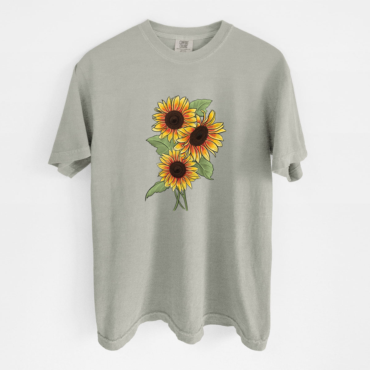 Sandstone beige Comfort Colors t-shirt laid flat, printed with a full-color illustration of a bunch of yellow and orange sunflowers.