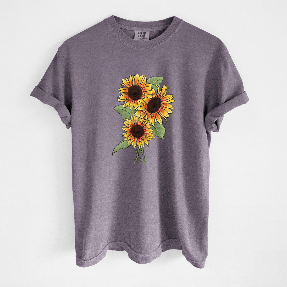Wine red Comfort Colors t-shirt laid flat, printed with a full-color illustration of a bunch of yellow and orange sunflowers.