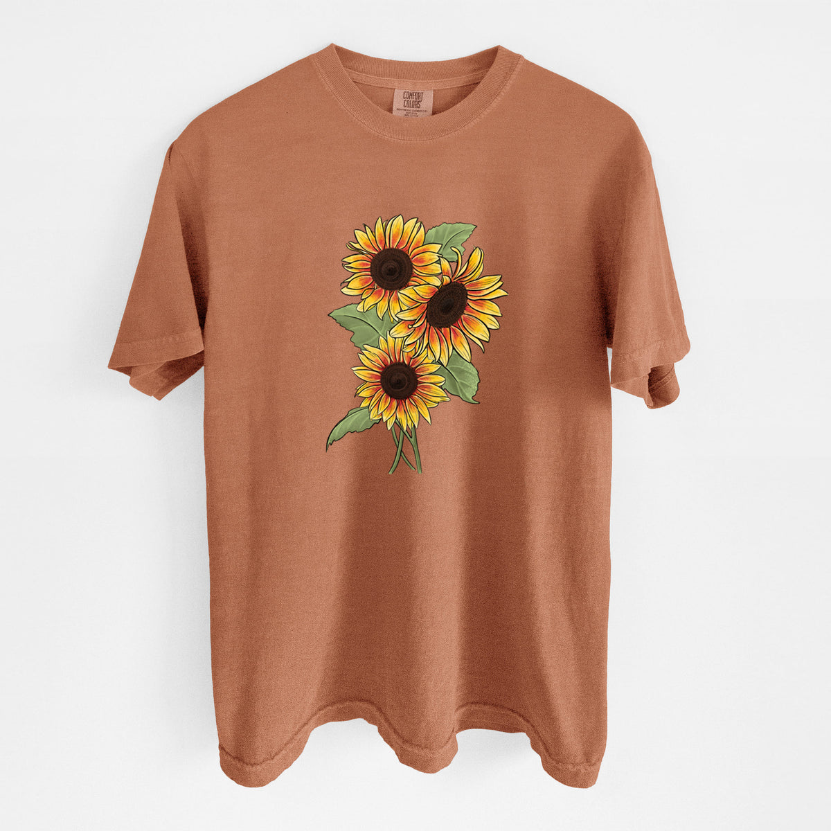 Yam burnt orange Comfort Colors t-shirt laid flat, printed with a full-color illustration of a bunch of yellow and orange sunflowers.