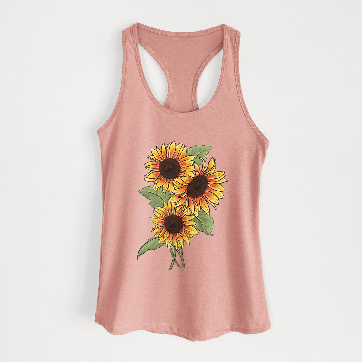 Desert pink women's racerback tank top laid flat, printed with a full-color illustration of a bunch of yellow and orange sunflowers.