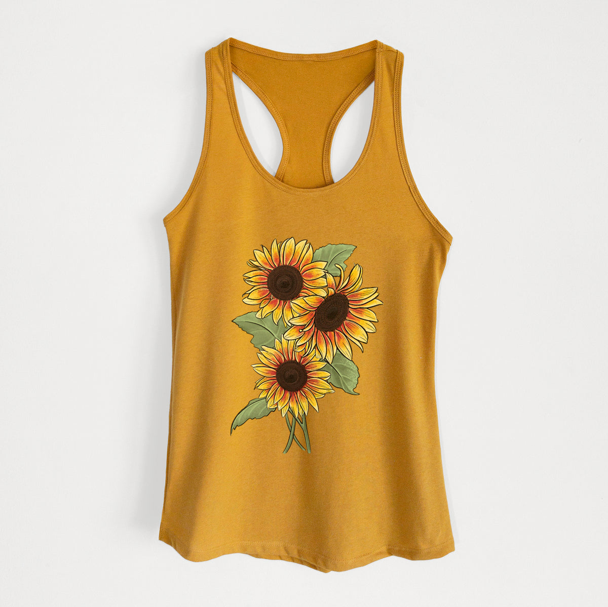 Gold women's racerback tank top laid flat, printed with a full-color illustration of a bunch of yellow and orange sunflowers.