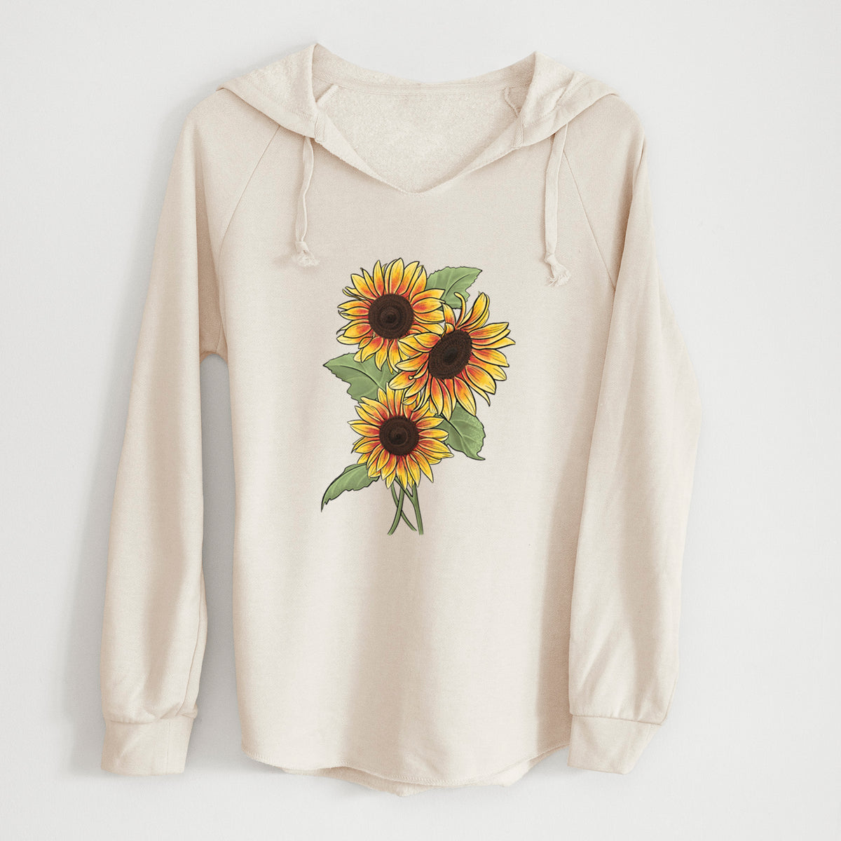 Bone cream women's Cali Wave hooded sweatshirt laid flat, printed with a full-color illustration of a bunch of yellow and orange sunflowers.