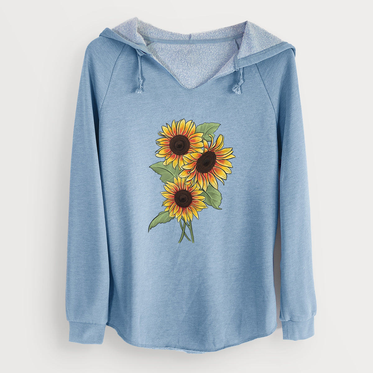 Misty blue women's Cali Wave hooded sweatshirt laid flat, printed with a full-color illustration of a bunch of yellow and orange sunflowers.