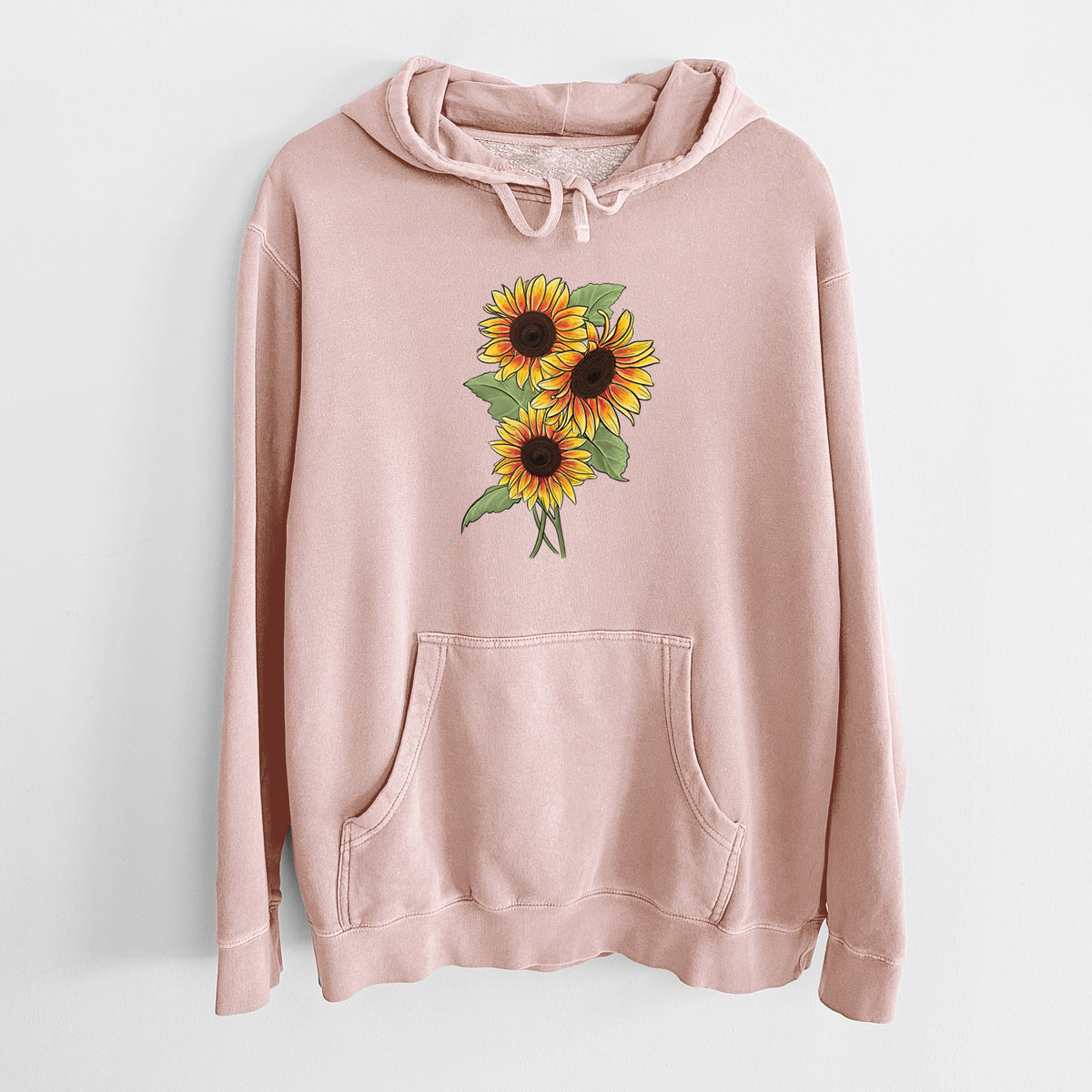 Dusty pink pigment dyed hoodie laid flat, printed with a full-color illustration of a bunch of yellow and orange sunflowers.