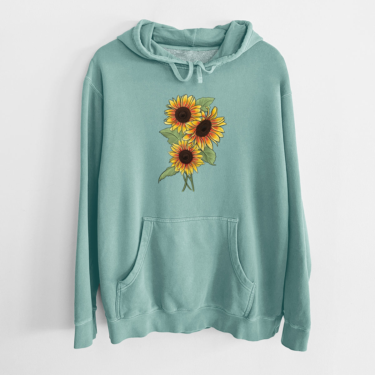 Mint green pigment dyed hoodie laid flat, printed with a full-color illustration of a bunch of yellow and orange sunflowers.