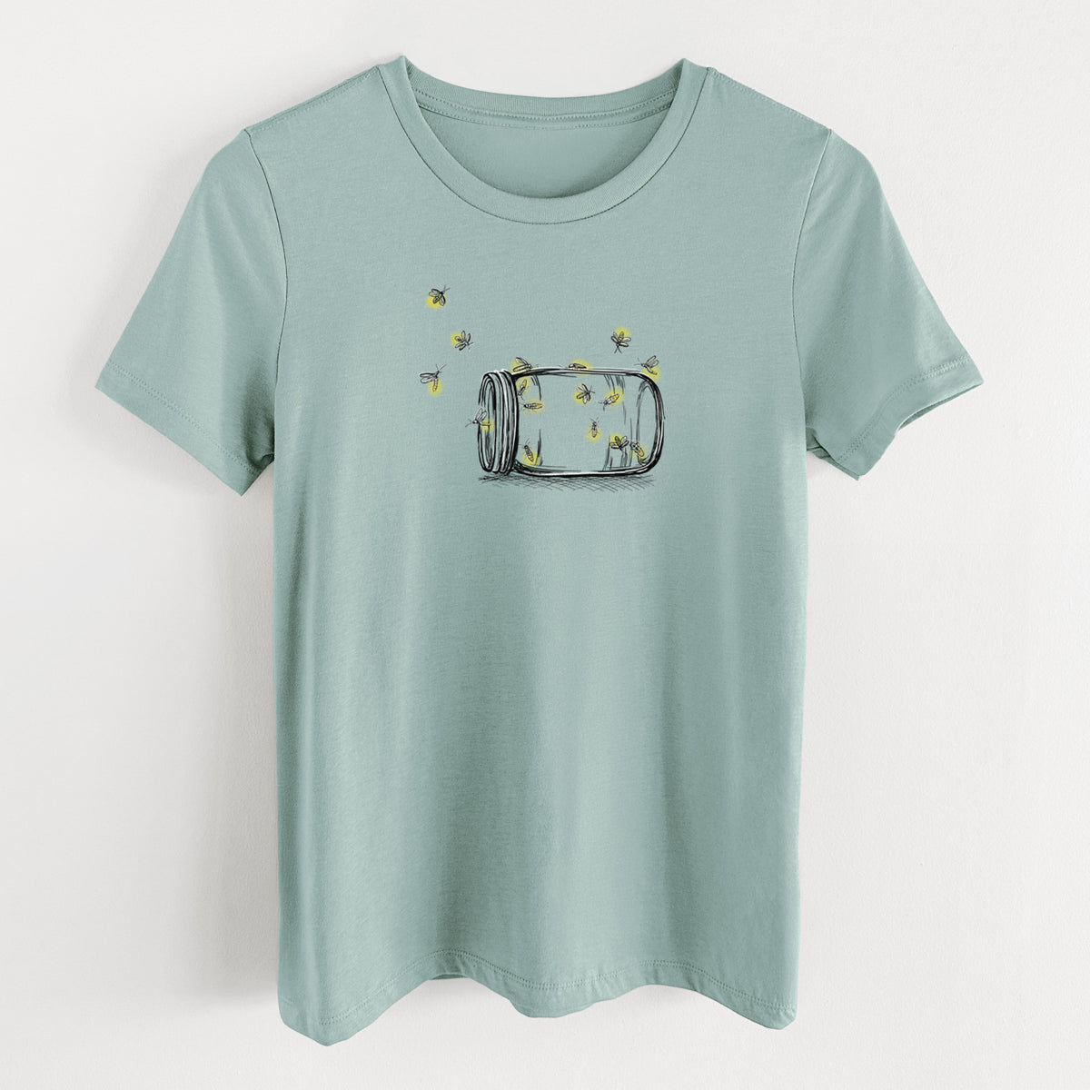 Dusty blue women's relaxed fit cotton t-shirt laid flat, printed with a mason jar with glowing yellow fireflies flying out of it.