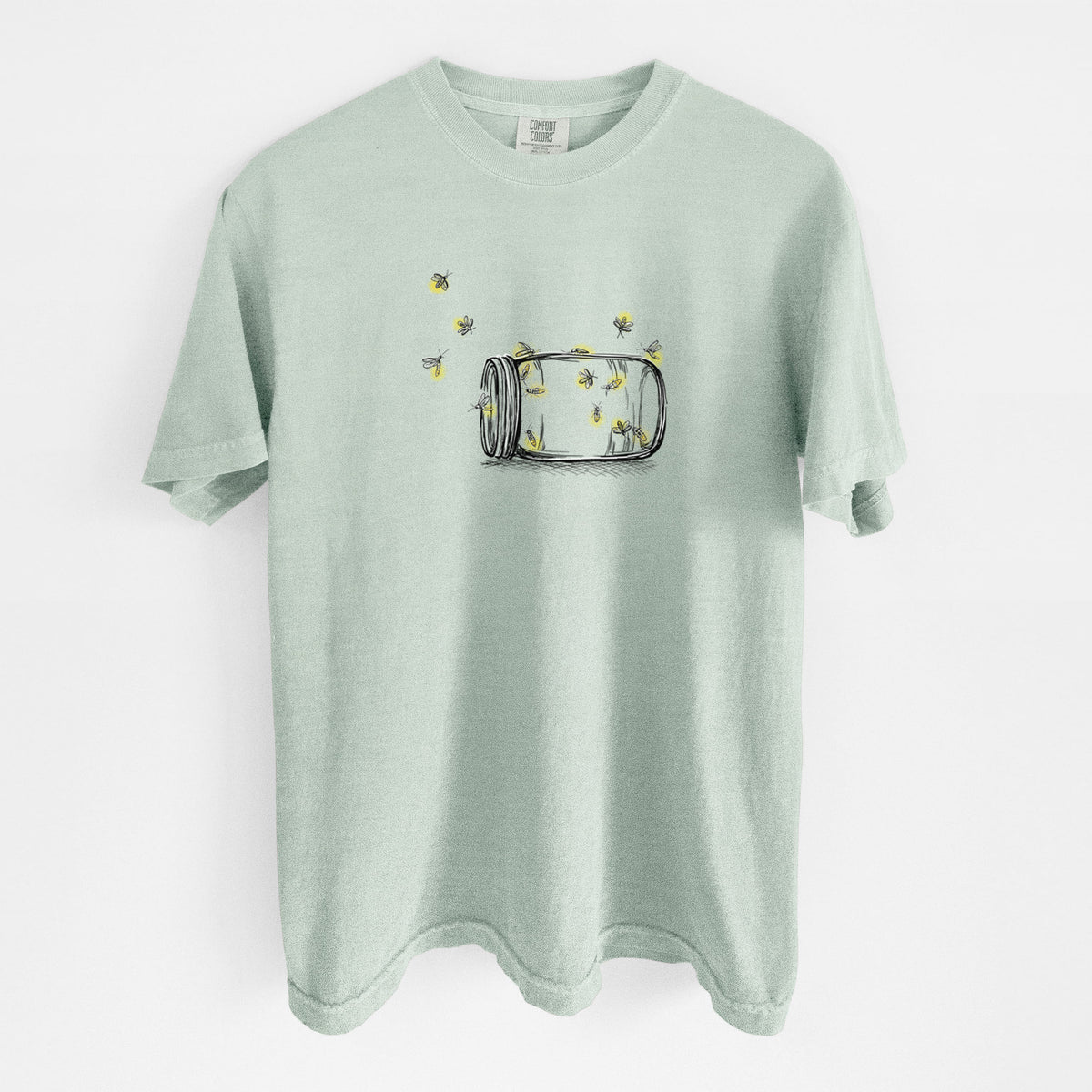 Bay green Comfort Colors t-shirt laid flat, printed with a mason jar with glowing yellow fireflies flying out of it.