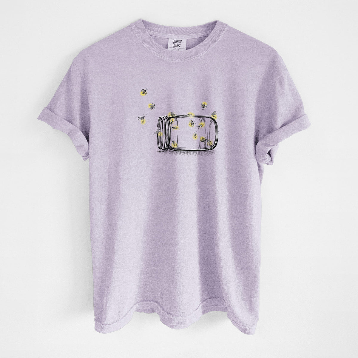 Orchid purple Comfort Colors t-shirt laid flat, printed with a mason jar with glowing yellow fireflies flying out of it.