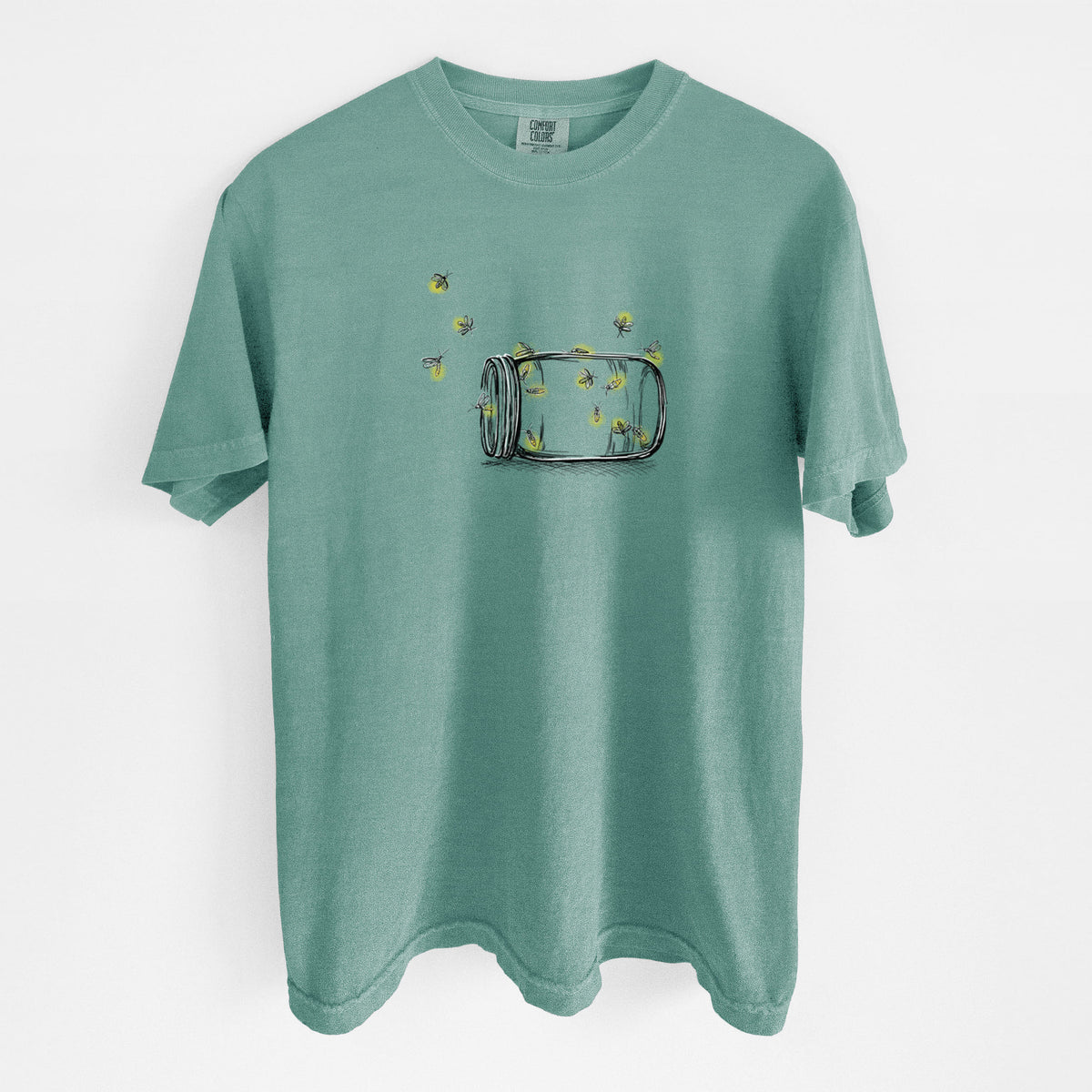 Reef green Comfort Colors t-shirt laid flat, printed with a mason jar with glowing yellow fireflies flying out of it.