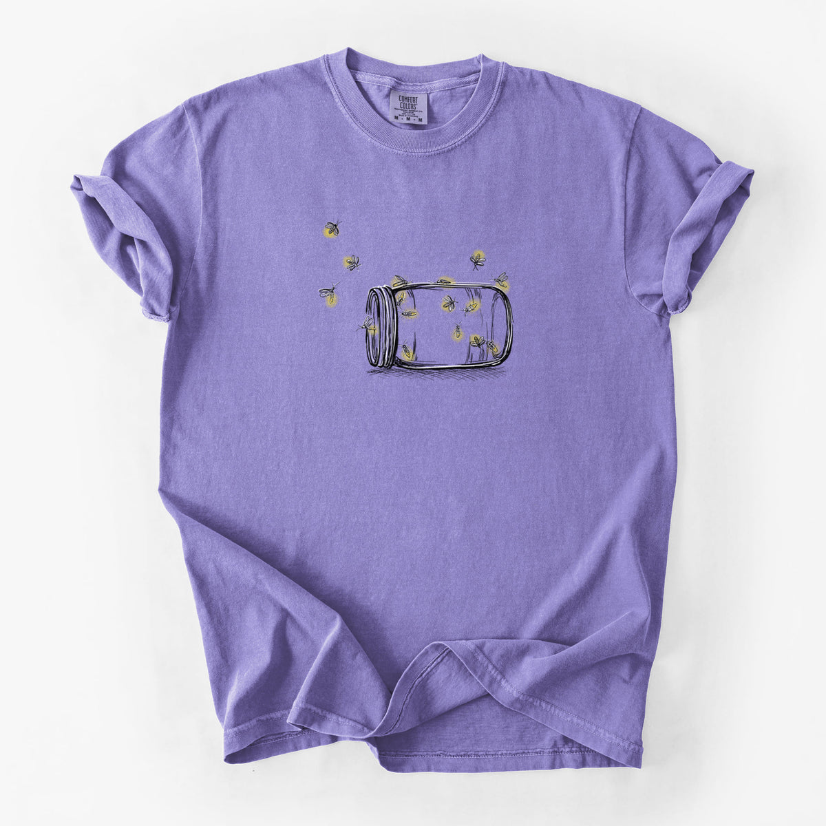 Violet purple Comfort Colors t-shirt laid flat, printed with a mason jar with glowing yellow fireflies flying out of it.