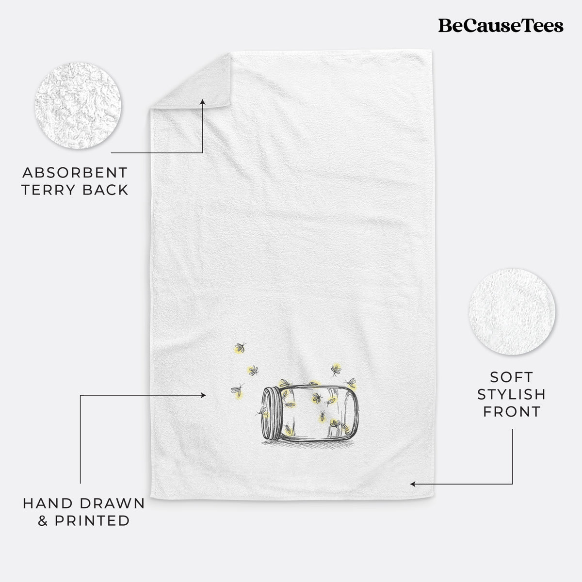 White hand towel printed with a mason jar with glowing yellow fireflies flying out of it.