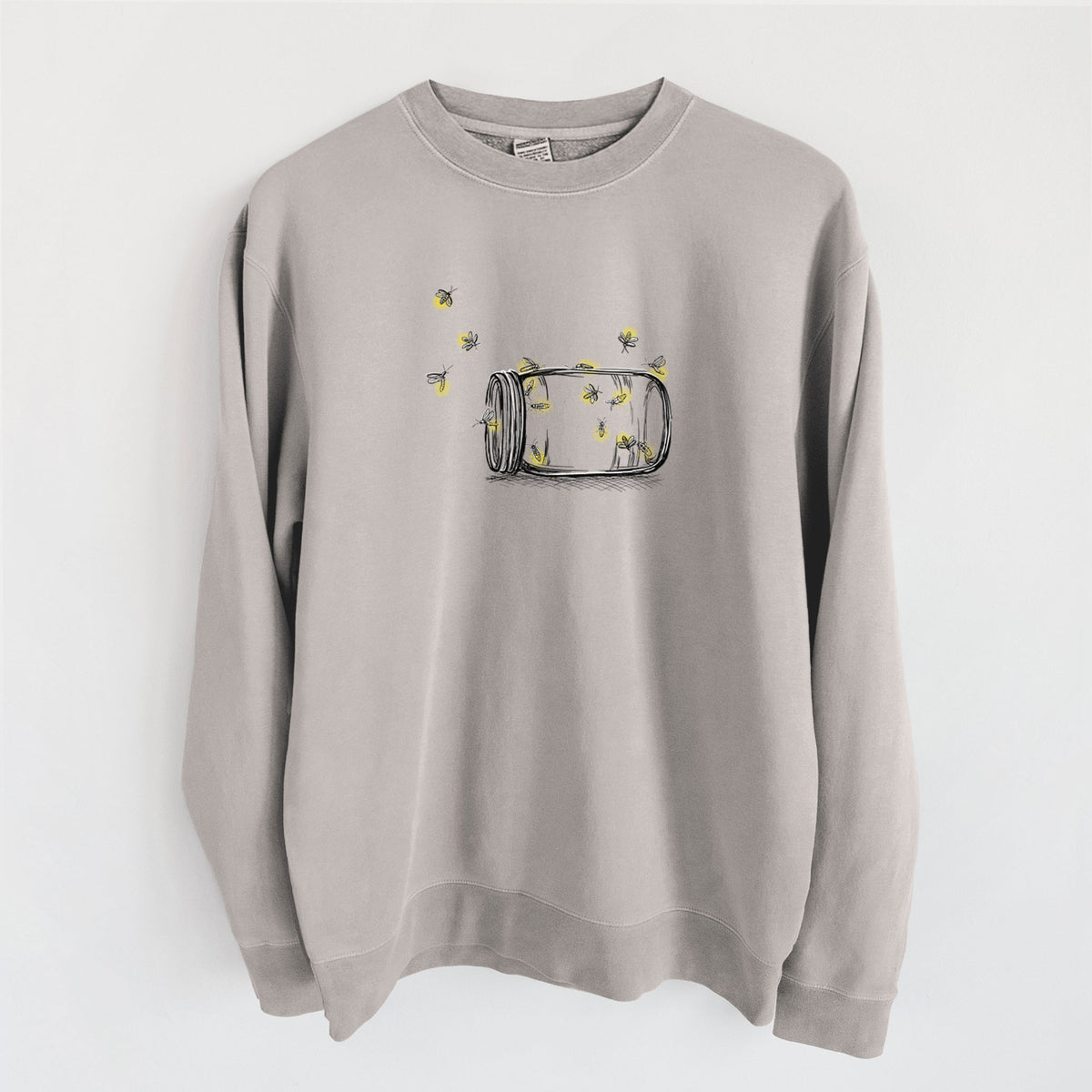Cement grey pigment dyed crewneck sweatshirt laid flat, printed with a mason jar with glowing yellow fireflies flying out of it.