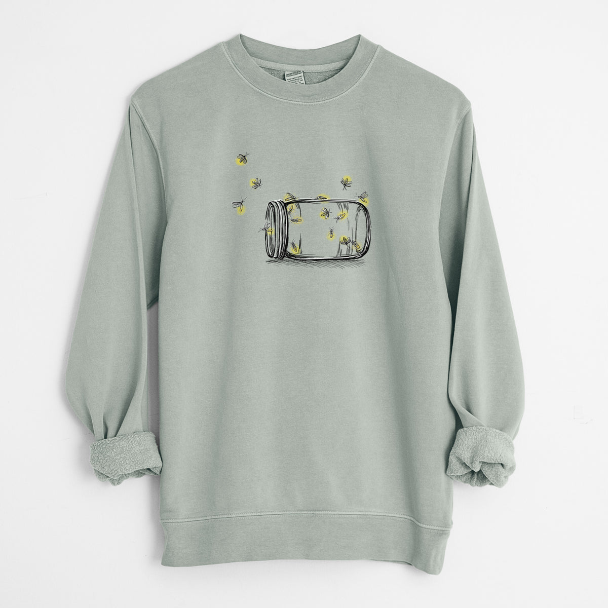 Sage green pigment dyed crewneck sweatshirt laid flat with the sleeves rolled, printed with a mason jar with glowing yellow fireflies flying out of it.
