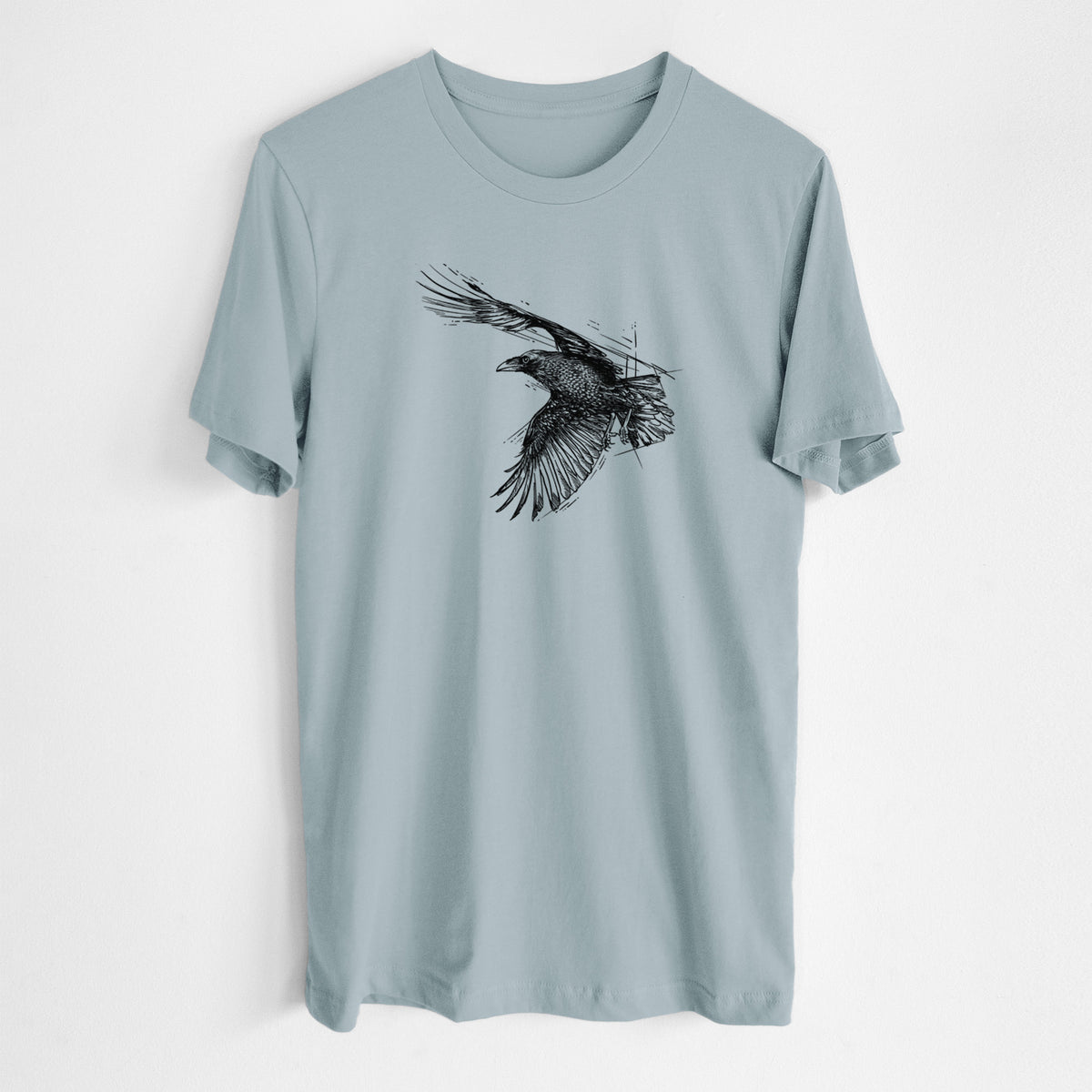 Vintage denim lightweight cotton t-shirt laid flat, printed with a black ink illustration of a raven in flight with its wings spread.