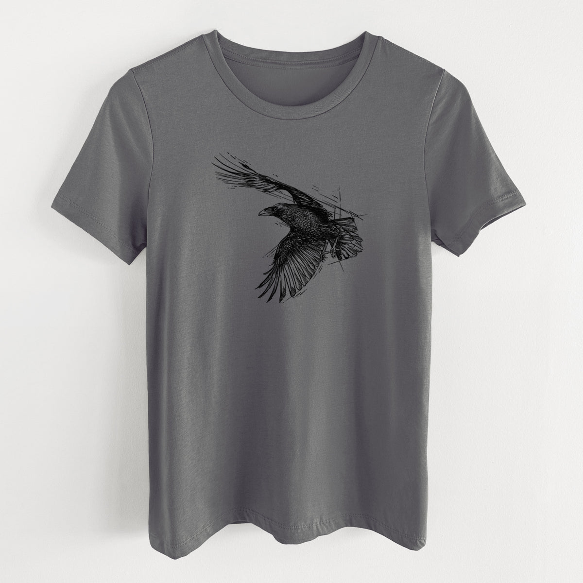 Asphalt women's relaxed fit cotton t-shirt laid flat, printed with a black ink illustration of a raven in flight with its wings spread.