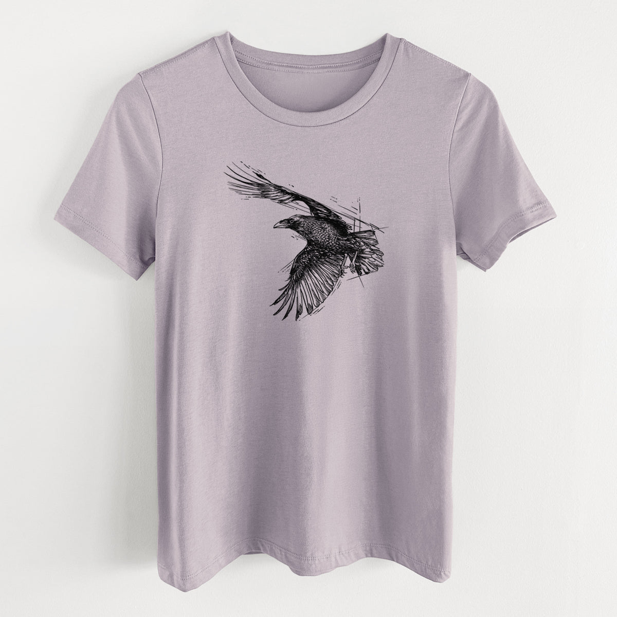 Light violet women's relaxed fit cotton t-shirt laid flat, printed with a black ink illustration of a raven in flight with its wings spread.