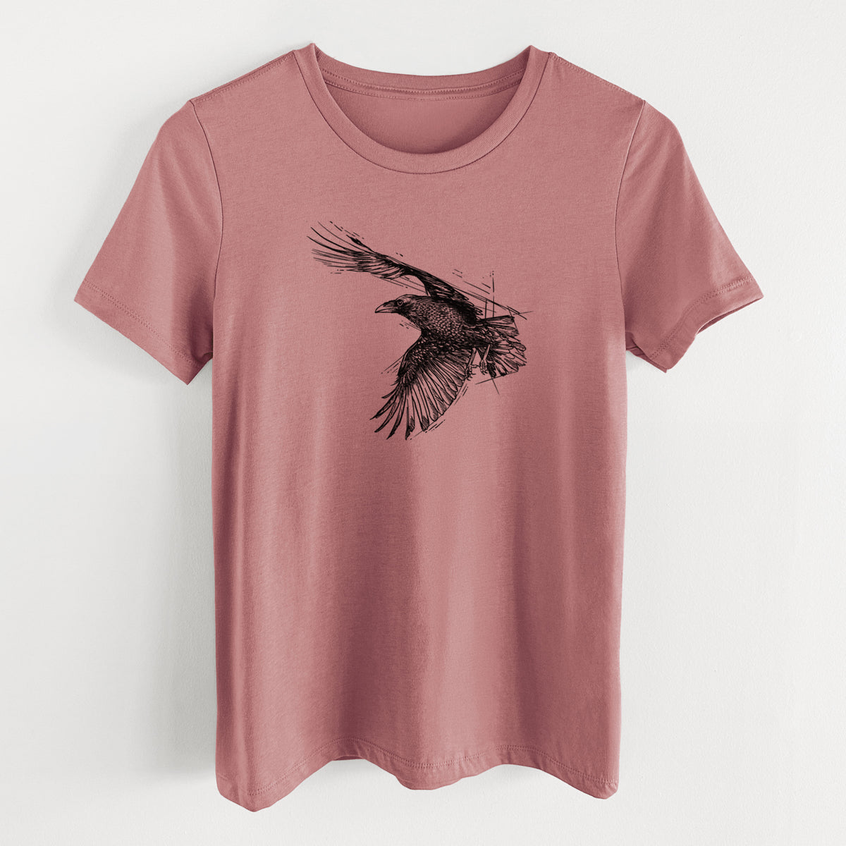 Mauve pink women's relaxed fit cotton t-shirt laid flat, printed with a black ink illustration of a raven in flight with its wings spread.