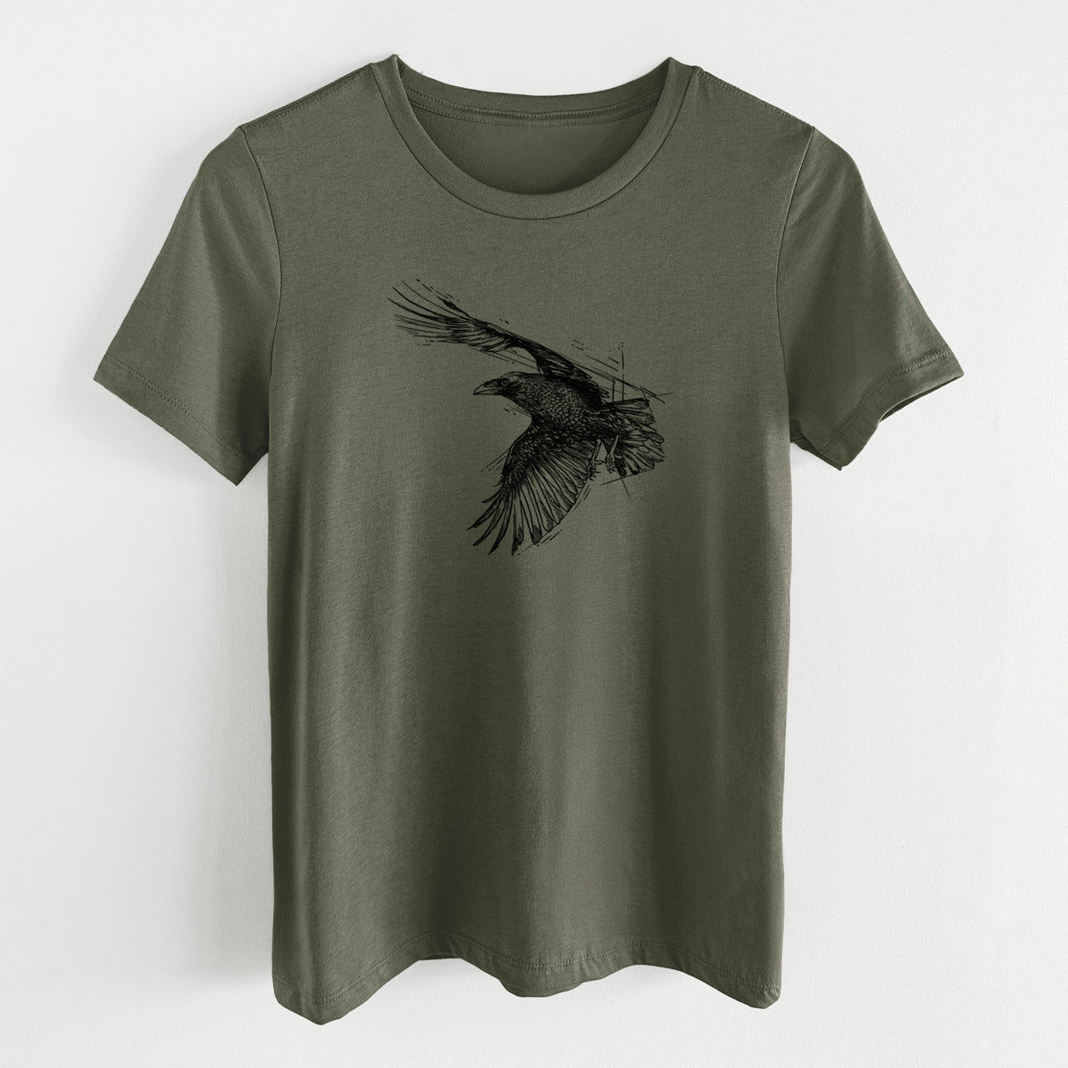 Military green women's relaxed fit cotton t-shirt laid flat, printed with a black ink illustration of a raven in flight with its wings spread.