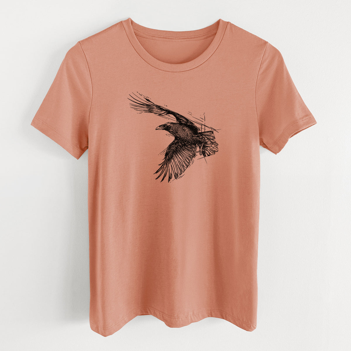 Terracotta orange women's relaxed fit cotton t-shirt laid flat, printed with a black ink illustration of a raven in flight with its wings spread.
