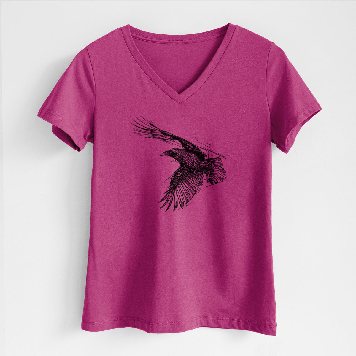 Berry pink women's relaxed fit cotton V-neck t-shirt laid flat, printed with a black ink illustration of a raven in flight with its wings spread.