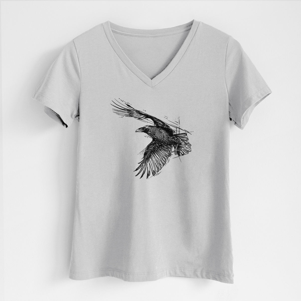Lunar grey women's relaxed fit cotton V-neck t-shirt laid flat, printed with a black ink illustration of a raven in flight with its wings spread.
