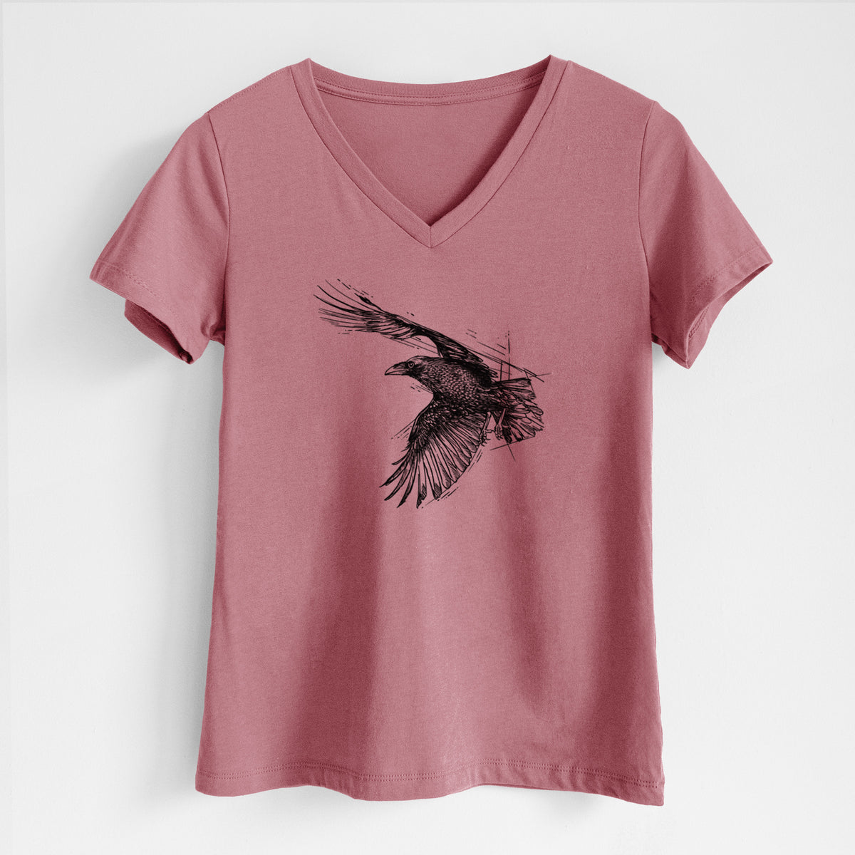 Mauve pink women's relaxed fit cotton V-neck t-shirt laid flat, printed with a black ink illustration of a raven in flight with its wings spread.