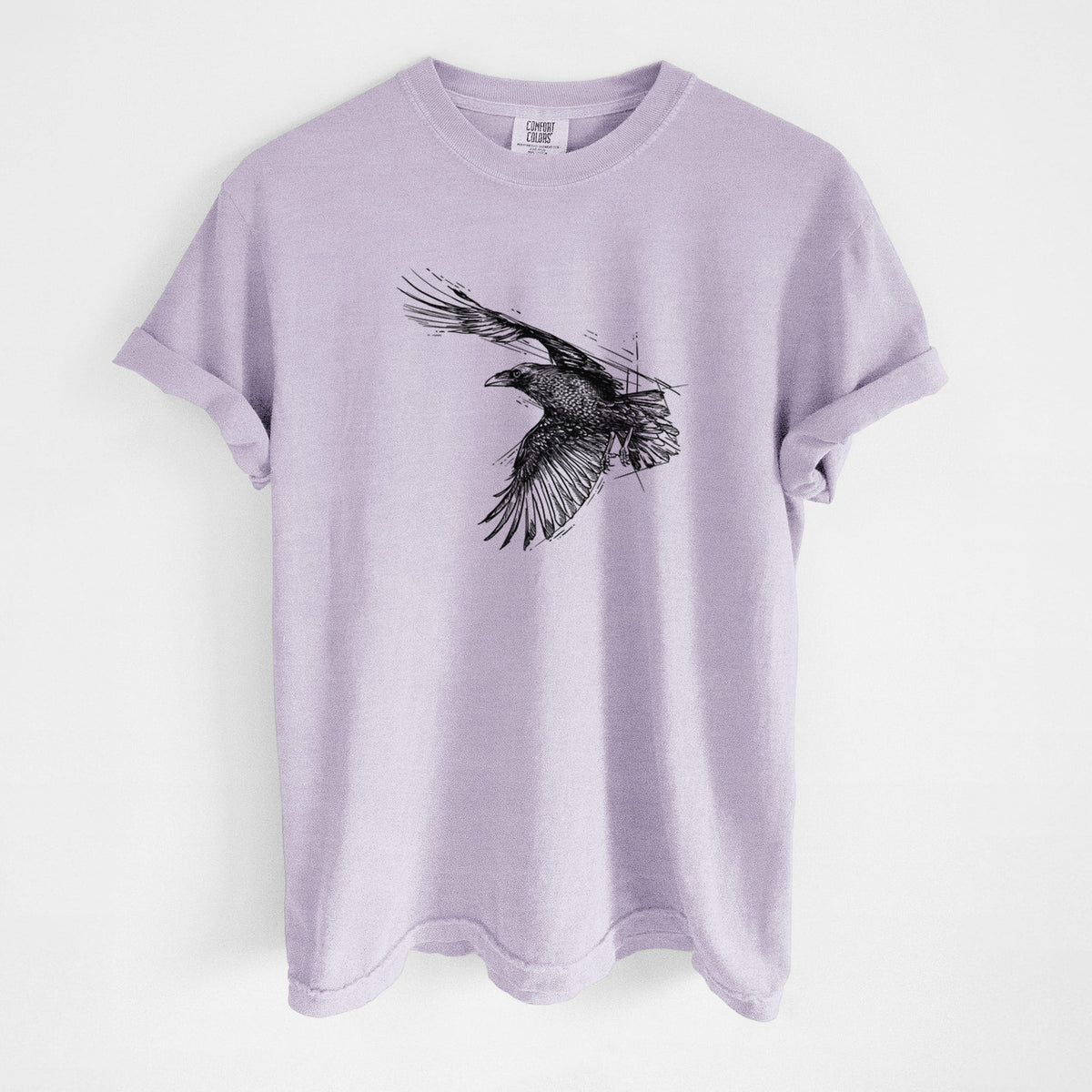 Orchid purple Comfort Colors t-shirt laid flat, printed with a black ink illustration of a raven in flight with its wings spread.
