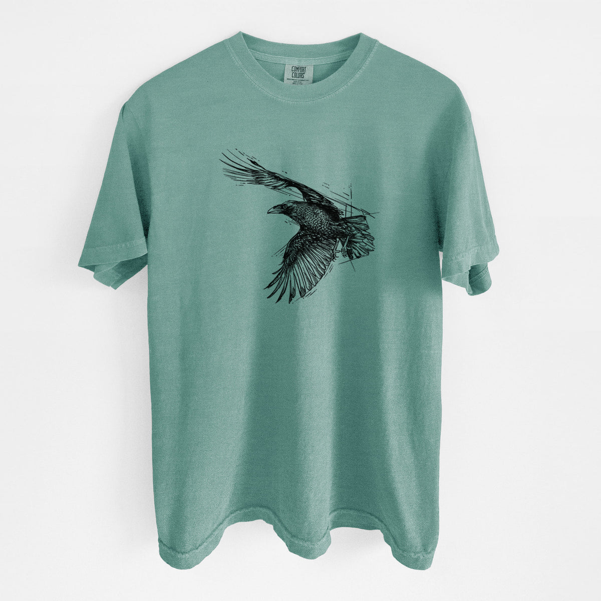 Reef green Comfort Colors t-shirt laid flat, printed with a black ink illustration of a raven in flight with its wings spread.