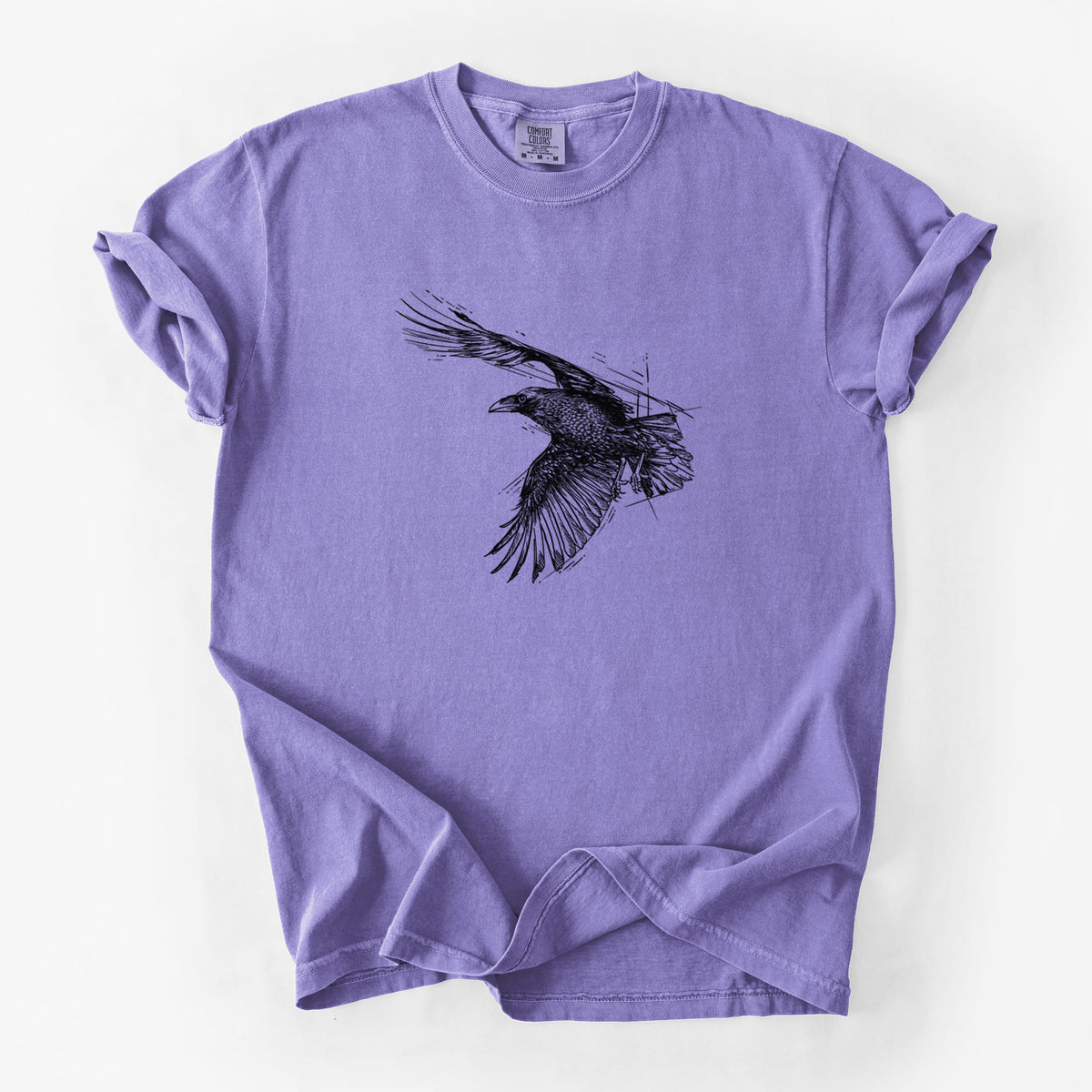 Violet purple Comfort Colors t-shirt laid flat, printed with a black ink illustration of a raven in flight with its wings spread.
