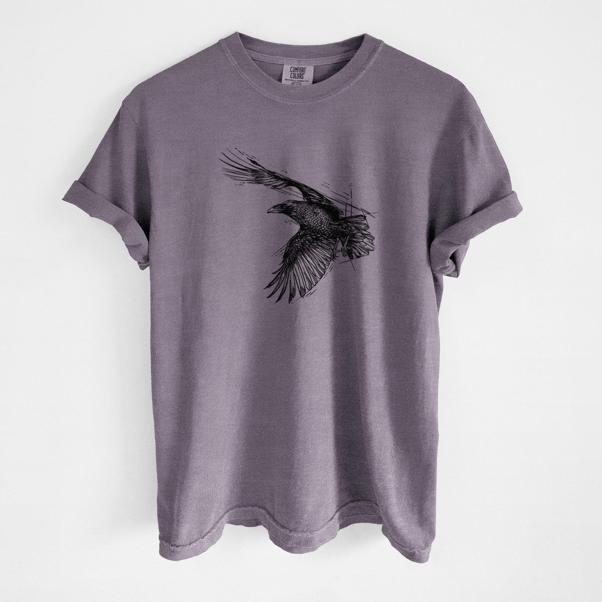 Wine red Comfort Colors t-shirt laid flat, printed with a black ink illustration of a raven in flight with its wings spread.