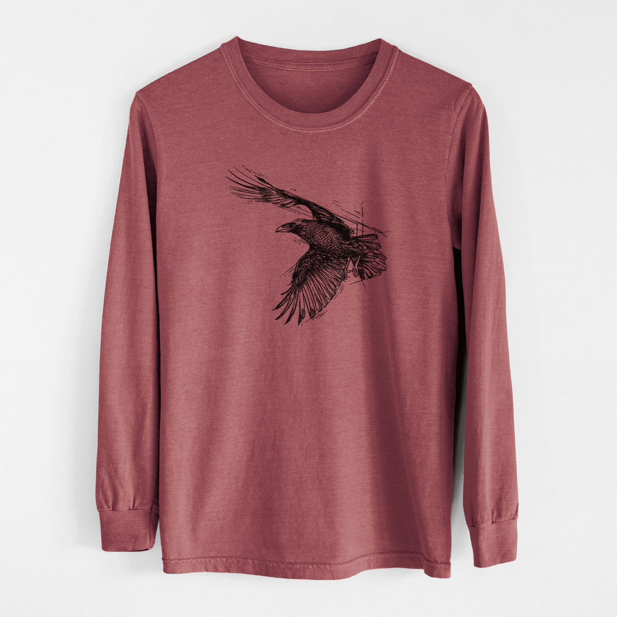 Brick red Comfort Colors long sleeve shirt laid flat, printed with a black ink illustration of a raven in flight with its wings spread.