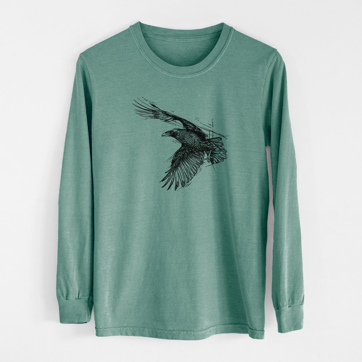 Pine green Comfort Colors long sleeve shirt laid flat, printed with a black ink illustration of a raven in flight with its wings spread.
