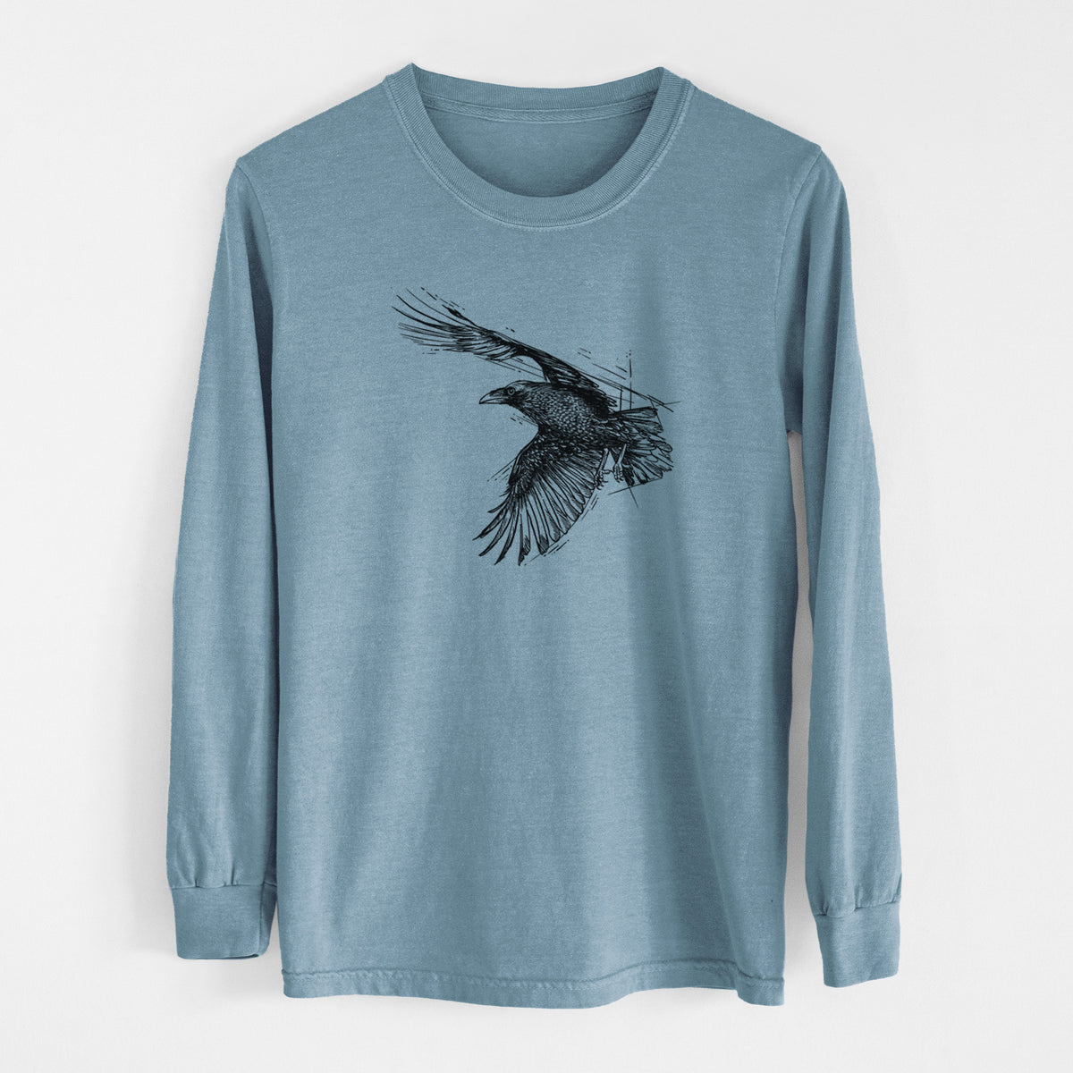 Steel blue Comfort Colors long sleeve shirt laid flat, printed with a black ink illustration of a raven in flight with its wings spread.