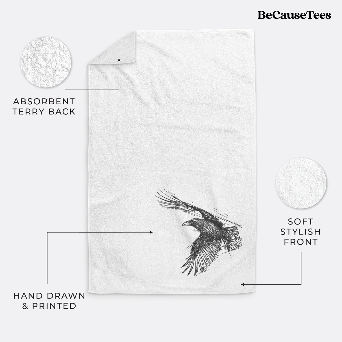 White hand towel printed with a black ink illustration of a raven in flight with its wings spread.