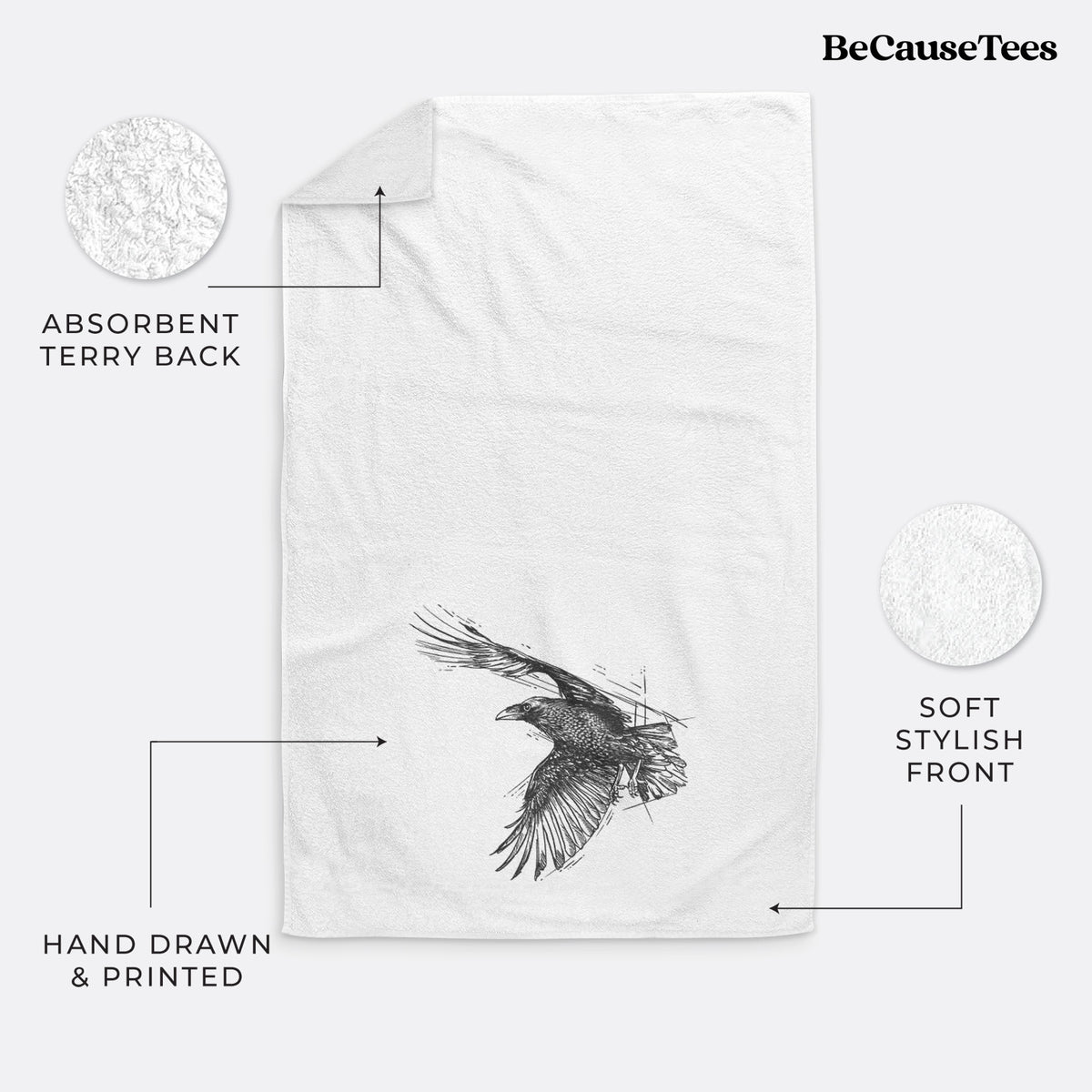 White hand towel printed with a black ink illustration of a raven in flight with its wings spread.